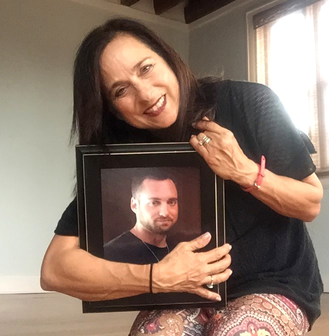 Tricia McCauley-Cox holds a photo of her late son, Max