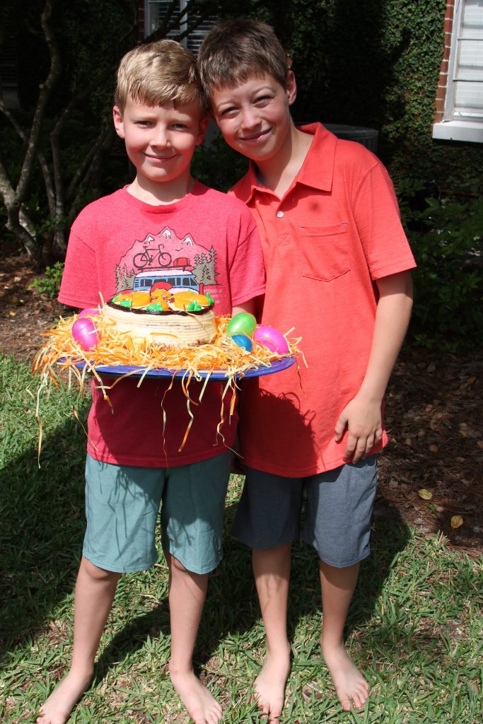 Nathan and William Allen with the cake Nathan won in the Easter Cake Walk at Holy Trinity Anglican Church April 13.