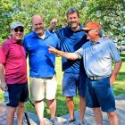 Steve Pajcic, right, points at Thomas Lloyd, a prior year hole-in-one challenge winner. With them are Walt Nicholson and his brother, Marvin, who is Steve’s son-in-law.