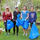 Danielle Hicks, Rebecca Rhoda, Kelley Towne and Jennifer Bundy cleaned up the Willow Branch waterway between St. Johns Avenue and Park Street, while Theo (front) and Murph enjoyed the chance to frolic in the parks.
