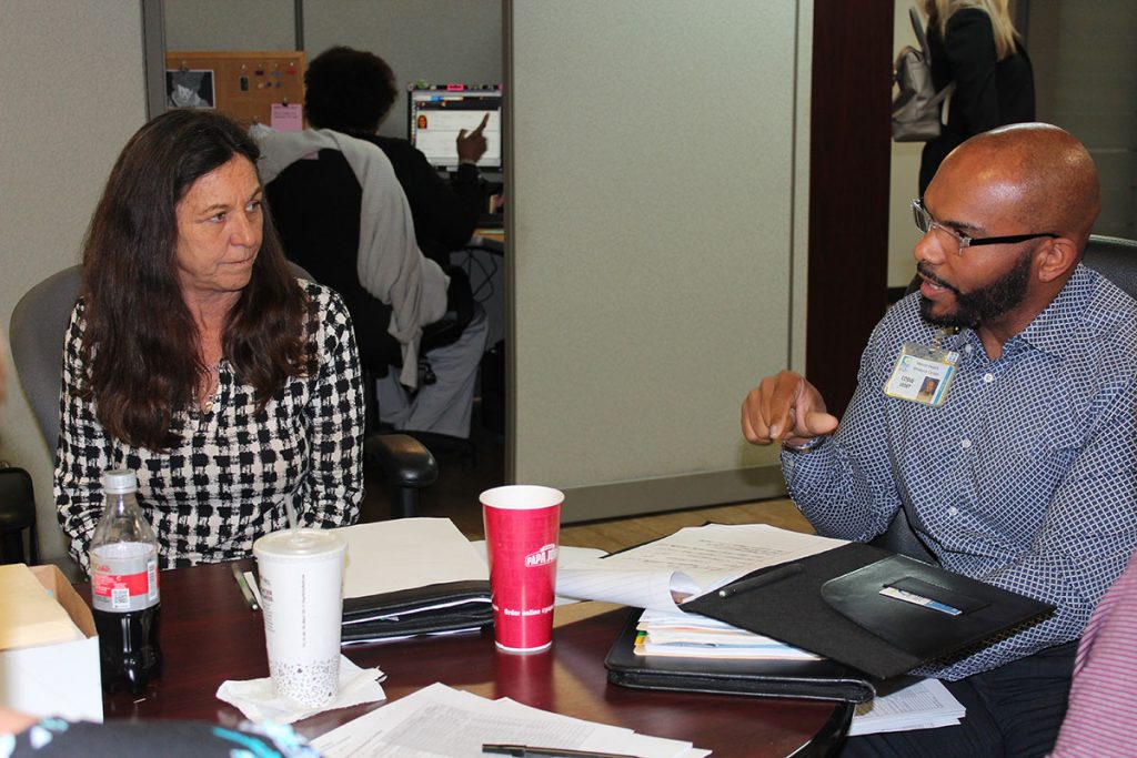 Mental Health Resource Center Vice President of Community Support Debra O’Neal listens as Eddie Ledet discusses weekly goals in an MHRC department meeting.