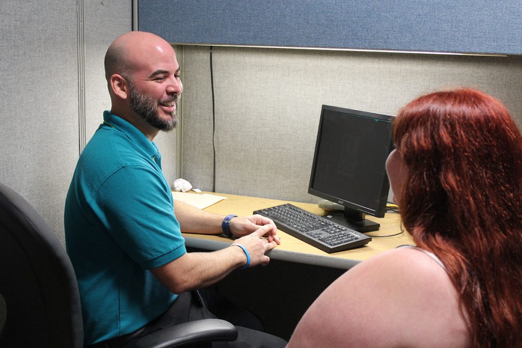 Carlos Laboy, Mental Health Resource Center program manager, speaks with a client about her needs.