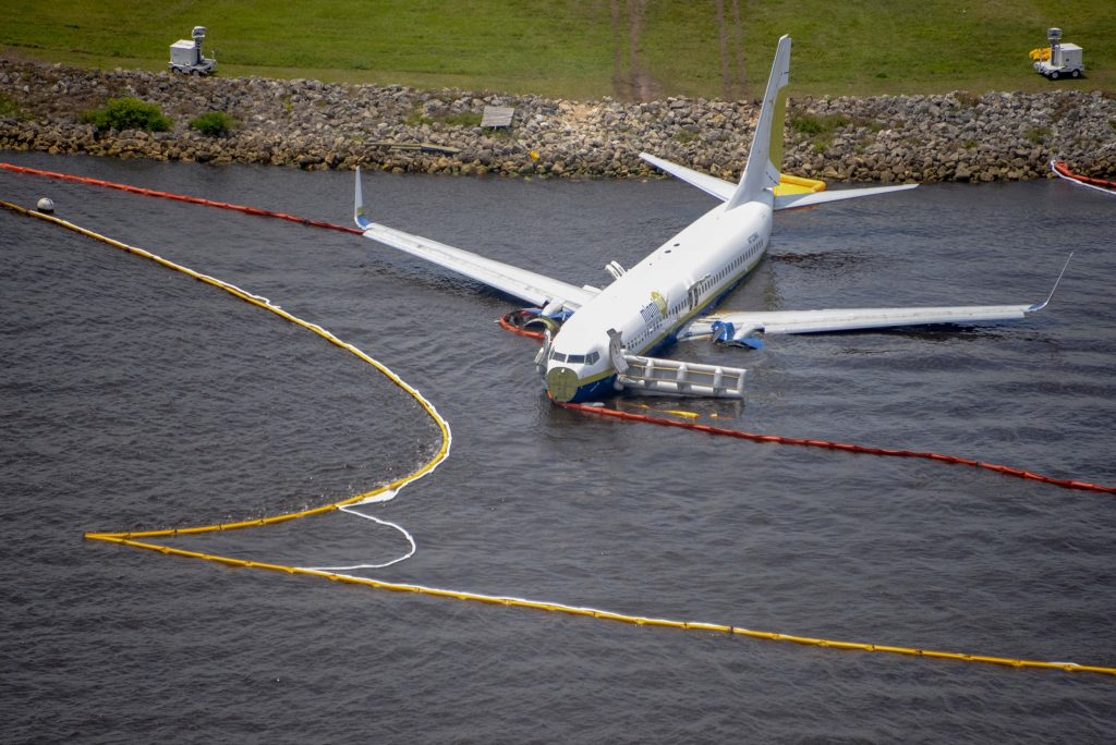 Containment and absorbent booms surround a Boeing 737 aircraft in the St. Johns River after the aircraft slid off the runway at Naval Air Station Jacksonville May 3. All 143 passengers aboard the flight from Naval Station Guantanamo Bay, Cuba were rescued by base fire rescue crews and JFRD. National Transportation Safety Board officials are on scene leading the investigation. (U.S. Navy photo by Mass Communication Specialist 3rd Class Thomas A. Higgins/Released)