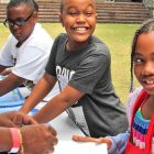 Central Riverside Elementary third graders Cedriontez Rogers, Donovan Zimmerman and Genesis Harrell pause for a photo op as they finish up a paint project before moving on to the next festival station at The Cummer.