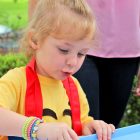 Central Riverside Elementary School pre-kindergartener Naomi Koch concentrates as she works on an art project at the Arts4All Festival.