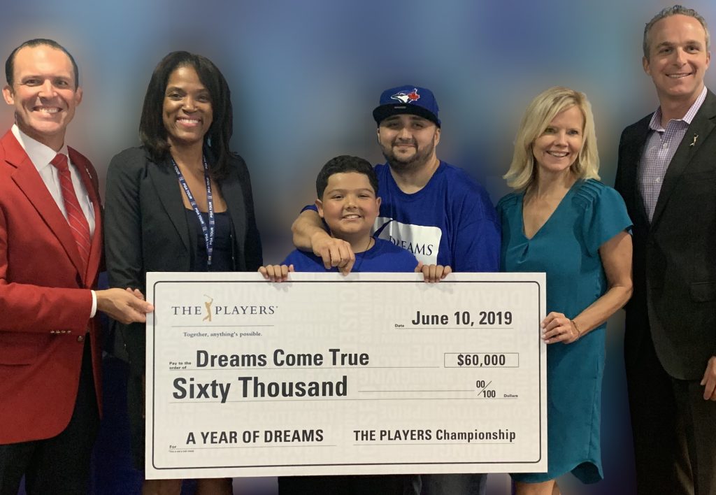 Dreams Come True was given a birthday surprise on Monday, June 10 when THE PLAYERS presented the locally based dream-granting organization with a $60,000 donation and a special birthday greeting from PGA TOUR member Fred Couples. (L-R) Adam Campbell, 2019 Tournament chairman, THE PLAYERS; Marsha Oliver, senior director, Community Outreach, THE PLAYERS; Dreamer Cristian Bernal (age 11) and his father John Bernal. Cristian’s Disney Dream in April 2019 was sponsored by THE PLAYERS; Sheri Criswell, executive director, Dreams Come True; Jared Rice, executive director, THE PLAYERS.