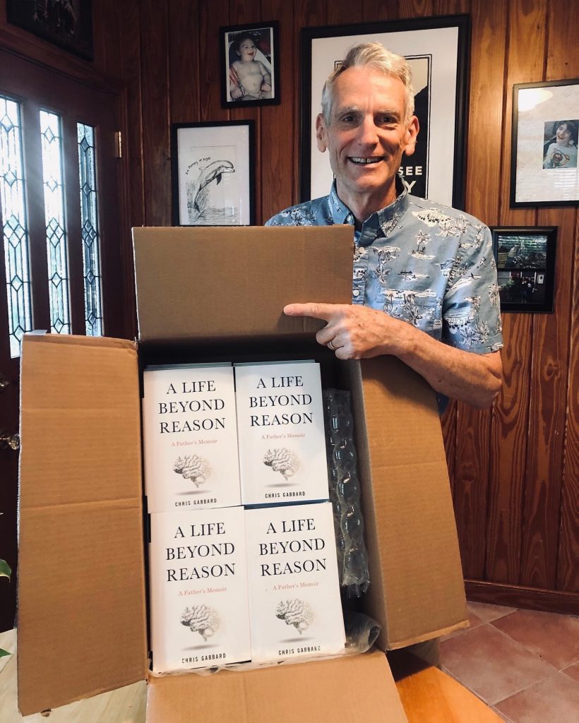 Just before Father’s Day, San Marco’s Chris Gabbard shows off a box of his book, “A Life Beyond Reason: A Father’s Memoir.”