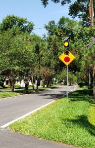 A new flashing signal on Yacht Club Road alerts vehicles to a stop sign at the intersection of Ortega Boulevard.