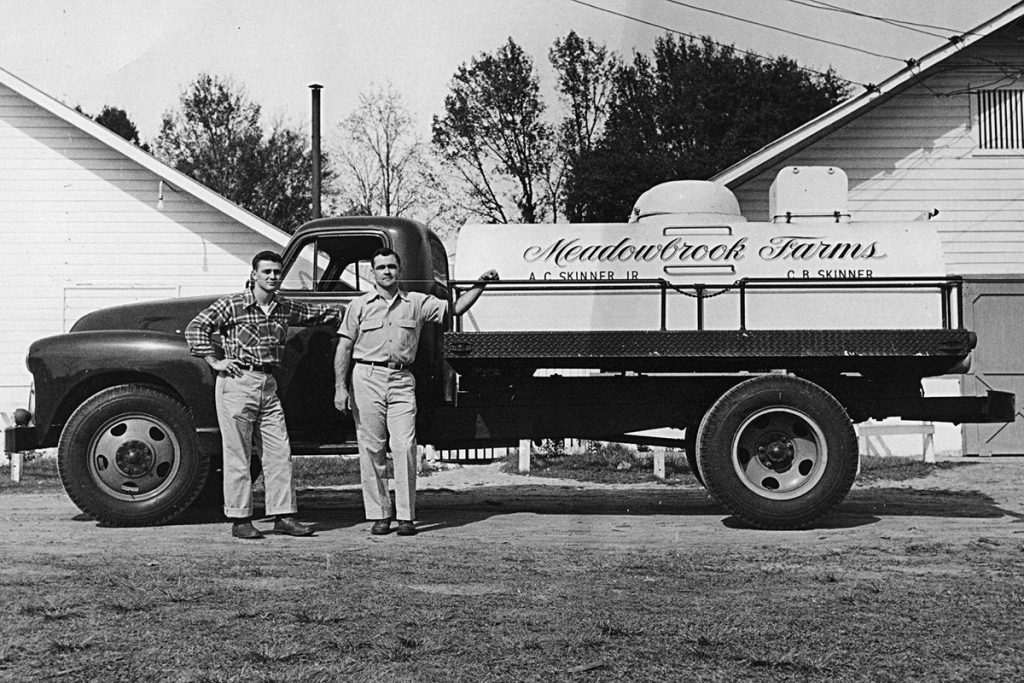 In the early days running Meadowbrook Farms dairy with Brightman, left, and Chester in front of one of their trucks.