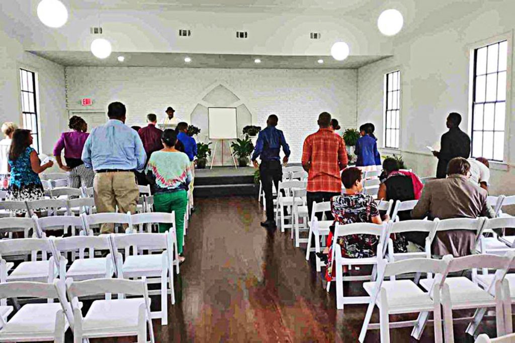 Mourners practice social distancing during a funeral service in the Naugle Schnauss Funeral Home’s Riverside chapel.