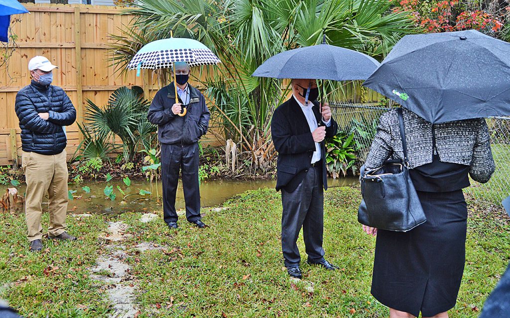 Florida State Representative Wyman Duggan and Jacksonville Chief of Engineering and Construction Management Bill Joyce, and District 14 City Councilwoman Randy DeFoor listen to Jacksonville Director of Public Works John Pappas talk with Palmer Avenue residents about their backyard drainage issues