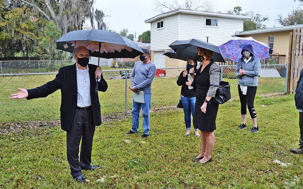 Jacksonville Director of Public Works John Pappas talks with Steve Jackson, Brooks Dame, District 14 City Councilwoman Randy DeFoor, and Rebecca Deacon and other residents about possible solutions for backyard flooding of their properties.