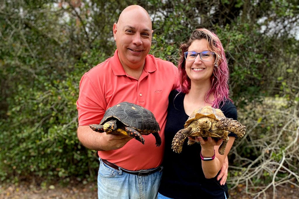 SCUTES Turtle Rescue founder Danielle D’Amato and her husband Pete Bis hold two common pet reptiles: on left/Pete - Red-Footed Tortoise, on right/Danielle - Sulcata Tortoise.