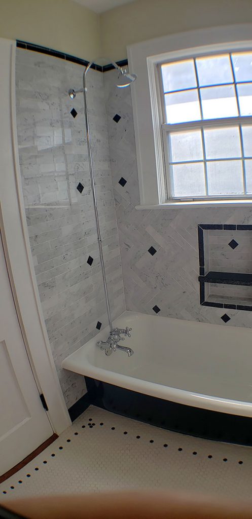 Lunn discovered the original hexagon porcelain tile floor under square ceramic tiles in the bathroom, which he demoed. He repaired the floor joists, installed a new floor that recreated the original look, and built a floating vanity and wall-to-wall, built-in cabinets.