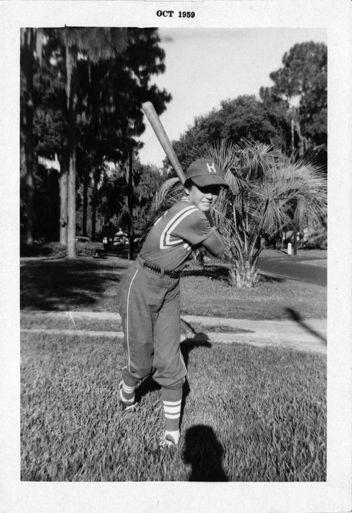 Karen in Little League uniform in front yard  of Peachtree Circle North home