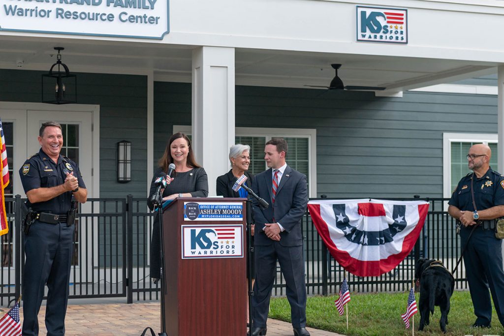 Speakers at K9s for Warriors Station Dog Ceremony - from left to right: Jacksonville Sheriff Mike Williams; Florida Attorney General Ashley Moody, K9s for Warriors Chief of Staff & General Counsel Patty Dodson; K9s for Warriors CEO Rory Diamond.