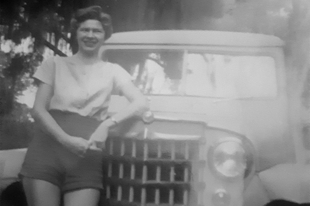 Linda Wood in front of Cynthia Segraves’s Willys Jeep Station Wagon