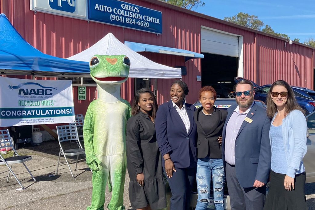 Laniya Flowers, 2022 Youth of the Year for Boys & Girls Clubs of Northeast Florida (BGCNF), is shown with her Boys & Girls Club “family” after being surprised with a Nissan Altima for her 19th birthday through the Recycled Rides Program. Shown are The GEICO Gecko; Latosha Nightengale, BGCNF Edward H. White Teen Center Unit director; Natasha Skipper, BGCNF Citi Teen Center Unit director; Laniya Flowers, BGCNF 2022 Youth of the Year; Kevin Carrico, BGCNF vice president of strategic initiatives; and Tracy Bishop, executive coordinator for the Florida Alliance of Boys & Girls Clubs.