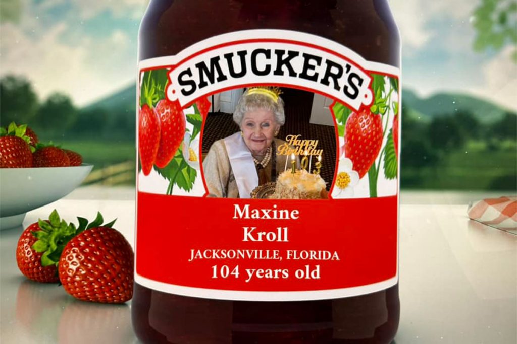 image of Smucker's jar with Maxine Meritt Kroll's photo on it and her name, "Jacksonville, Florida" and "104 years old" under the photo, all on the label