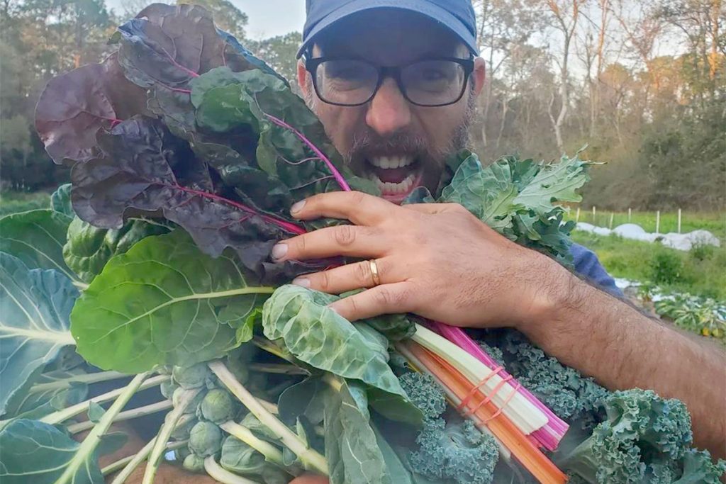 Brian and fresh leafy greens | Picture Credit - Down to Earth Farm