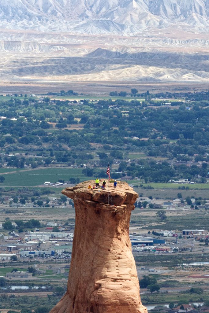 On Independence Day, eight local rock climbers scale the 450-foot-high walls of Colorado National Monument, formerly part of a massive eroded rock wall, to annually raise the American flag.