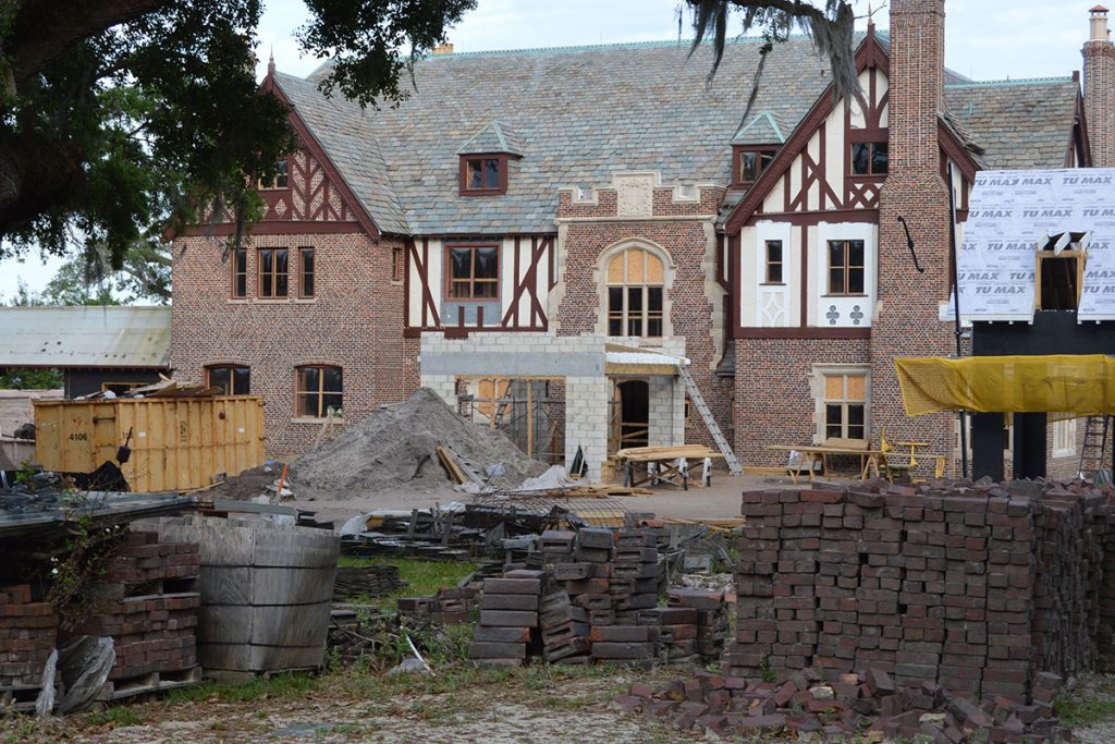 exterior photo of mansion with work being done to it