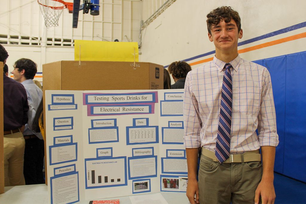 student with science fair exhibit