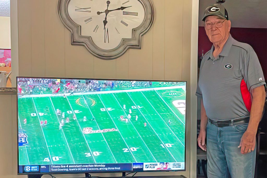 Leon next to a television gifted to him by four appreciative former Generals: Greg Carter, Phil Miller, Joe Joe Browder and Steve Hyers | Photo/Facebook-Leon Barrett