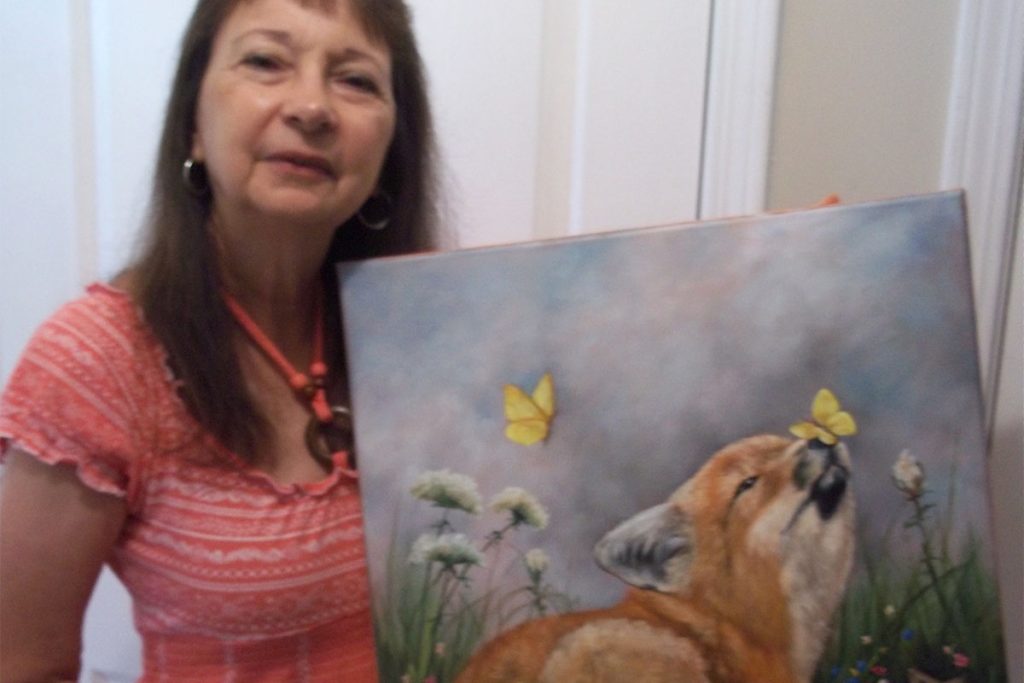 Laurel holding a painting of a fox