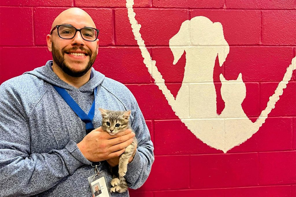 Mike Bricker holding a kitten, Skittles, at the ACPS facility.