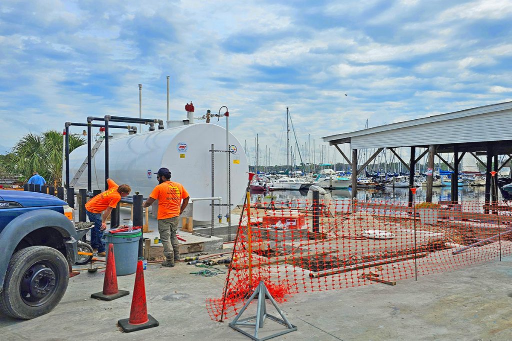 Crews working to install the new fuel tanks Windward Marina Group has brought to the marina.