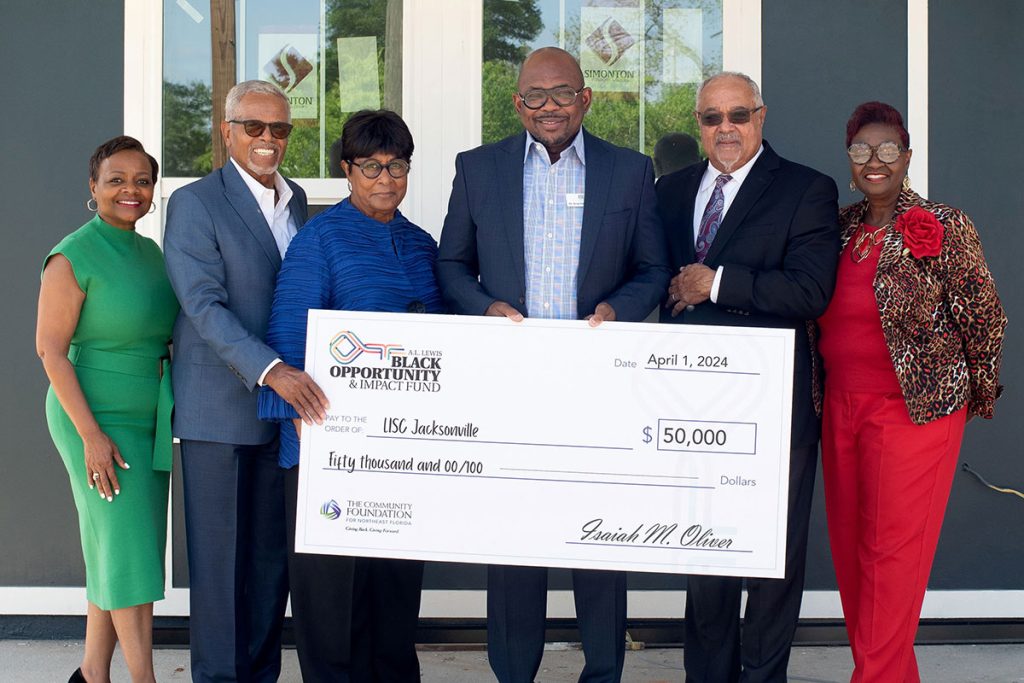 Wanda J. Willis, Gregory Owens, Velma Monteiro-Tribble, Irvin “Pedro” Cohen, Judge Brian Davis and Barbara Darby at the check presentation to LISC Jacksonville.