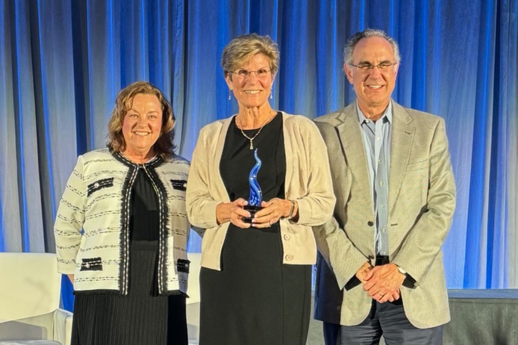 Florida Blue’s Susan Towler and Charlie Joseph with Candace Hodgkins, holding her 2024 Sapphire Award. | Photo/Florida Blue