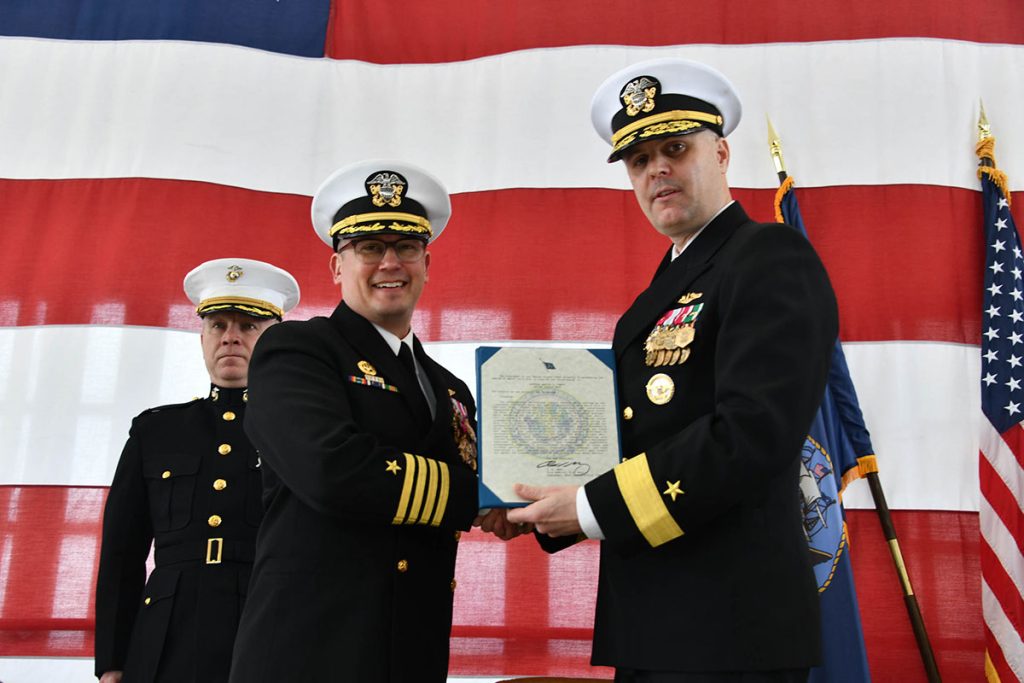 Cmdr. Navy Region Southeast Rear Adm. Ian Johnson, right, presents the Legion of Merit award to Naval Air Station Jacksonville Commanding Officer Capt. Marc Cantu during a change of command ceremony, Feb. 29.