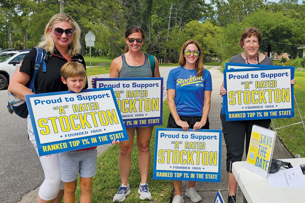 Inga Makarenko, Dominic T., Katie Williams, Lauren Agresti and Allison Cooke with signs supporting John N.C. Stockton Elementary School.