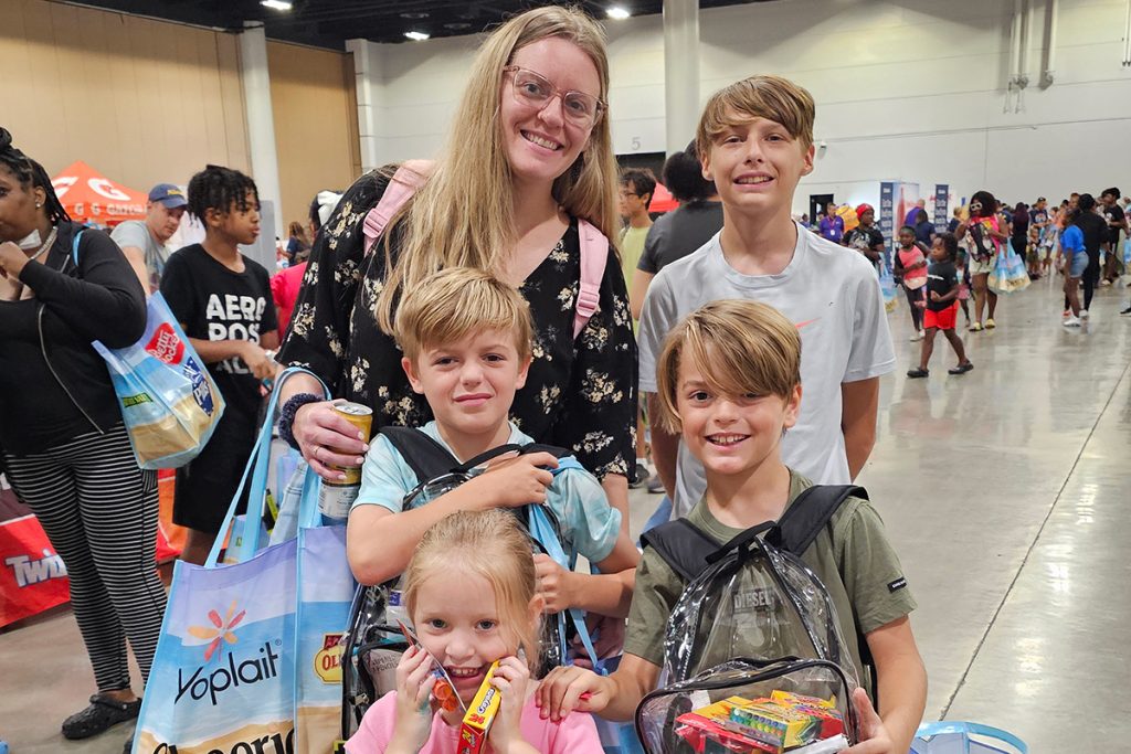 Sterling, Eli, Leo and Tavian show off their school supply haul at Pack the Sack II with their mom, Kaitlyn Peters.