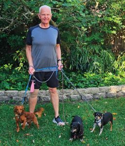 John Glessner with his dogs Louis, Leah and Leo