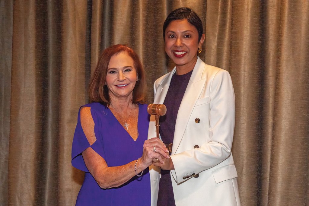 Sheila Collier passes the gavel to current president Sabeen Perwaiz at WGA’s annual meeting last October.
