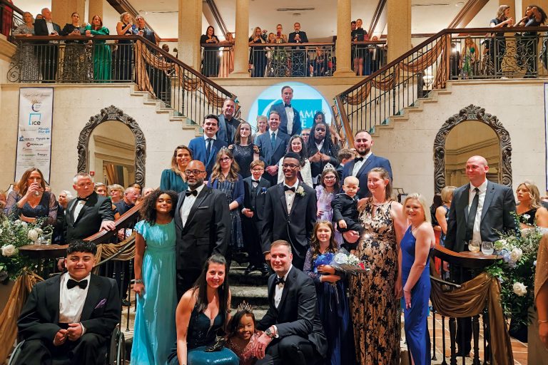 large group photo of people in front of, and going up double stairs, and on upper overlook