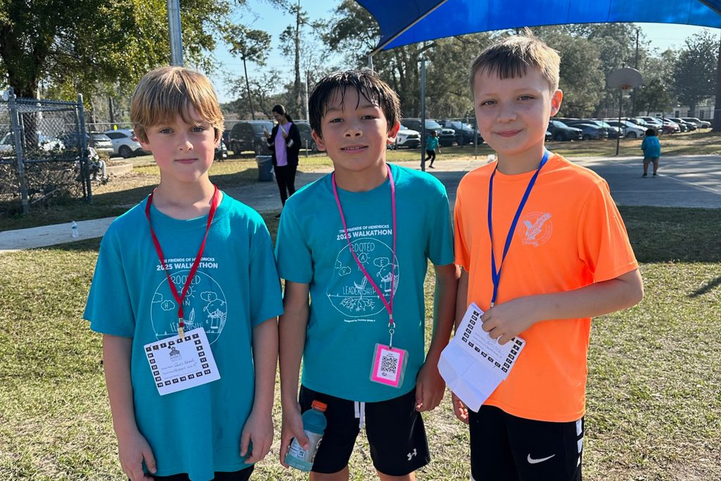 three boys smiling at camera