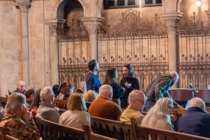 audience looking toward the stage in the church
