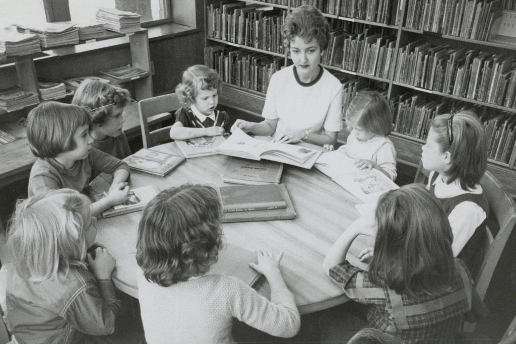 Mrs. Richard Moore from the Southside Branch Women’s Club reads to children during a Story Hour at Southside Branch Library.