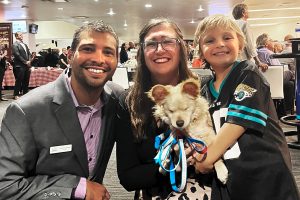 New CEO Nicolas with wife Tiffany Deaton-Nicolas, son Kellan, 6, and their blind JHS rescue Pomeranian/corgi mix that Kellan named Juicebox.
