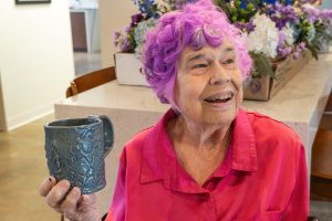 Kathy admiring her work and her gifts as a clay artist at Rainbow Workshop