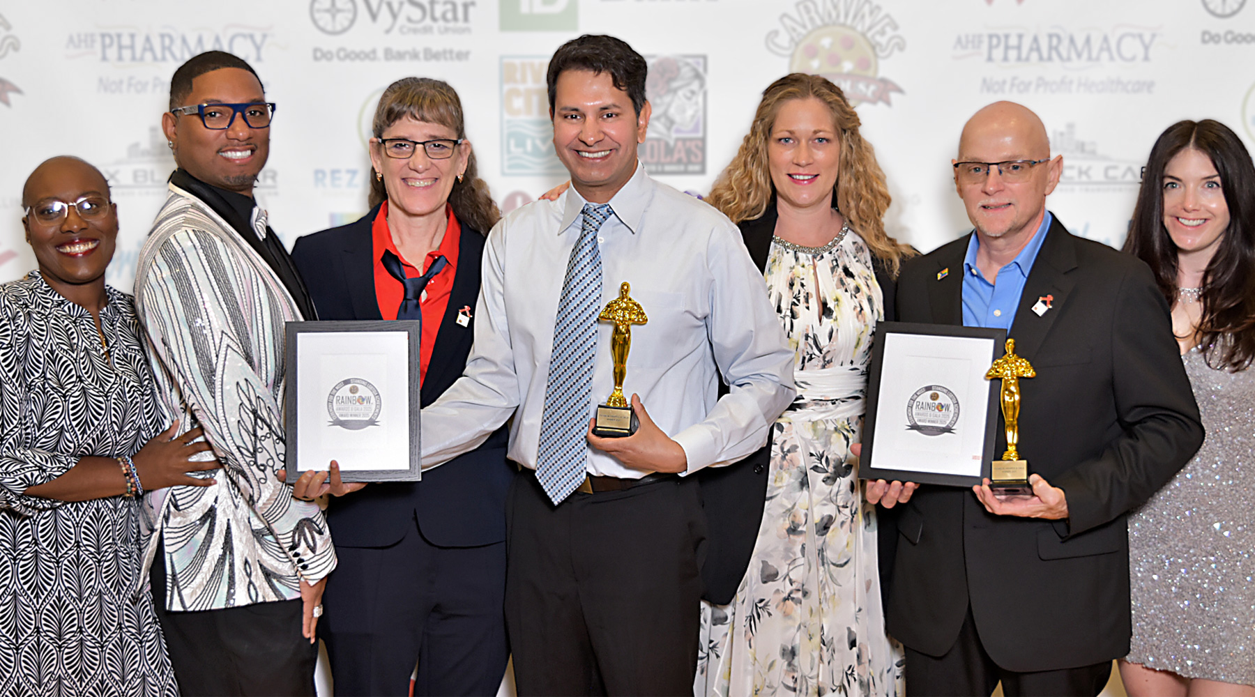 smiling people holding awards