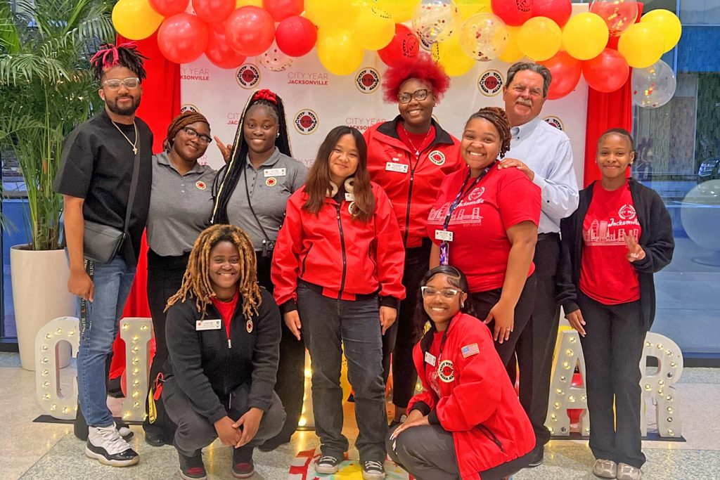 City Year Student Success Coaches (Back Row) Za’vion Houston, Marquette Merritt and Eugina Holsey with Tyasia Saunders, Event Sponsor and Advisory Board Member Michael Ward and Kai’liyah. (Front Row) Arri Fleming and June Sundiang with Kayla Smothers and Bee Devaughn