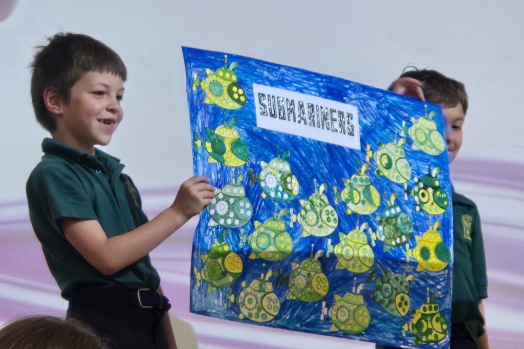 Students give a presentation about submariners as part of St. Paul’s Catholic School Riverside’s Month of the Military Child celebrations.