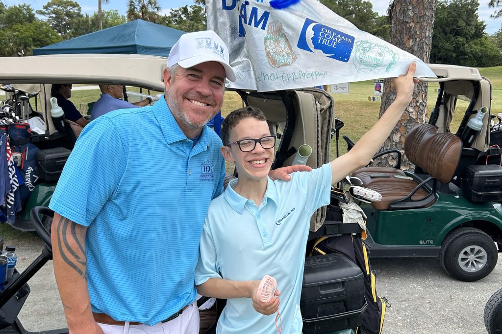 Golfer Steve Butler proudly displayed on his golf cart a flag decorated by Golf Ambassador Landon Cartwright.