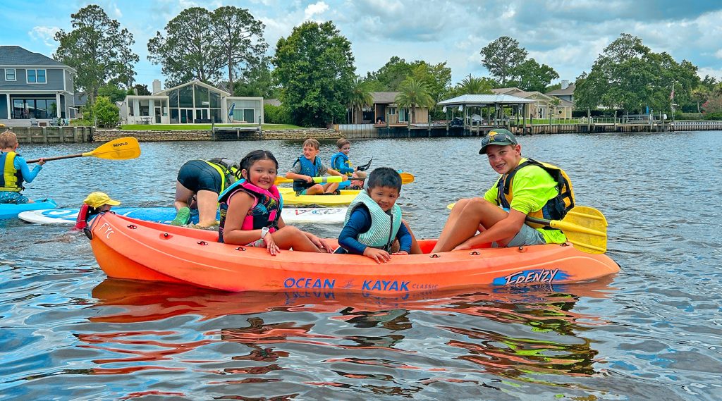 Addison and Emilia C. kayak together with instructor Mack Mairs in FYC’s Water Wiggler and Adventurer groups