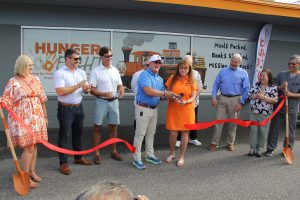 Dean and Sherri Porter cut the ribbon at the July 24 ceremony, joined by Hunger Fight Board members Angela Campbell, Chris Wilson, James Pyle, Nathan Dowd, Glenn East, Steve Wetherell, Dr. Pamela Santelices (not a board member) and Dr. Sam Santelices.